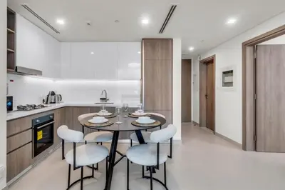 a kitchen with a table and chairs in a room at Exclusive Marina Lifestyle with Stunning Views in Dubai