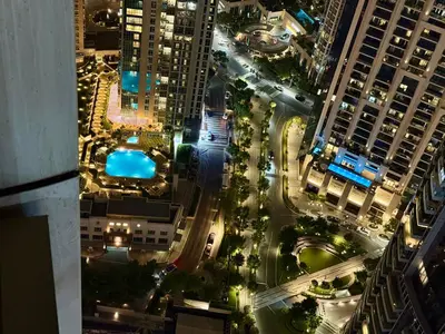 an aerial view of a city at night at Skyline Escape 2BR with Balcony Pool & Gym in Dubai