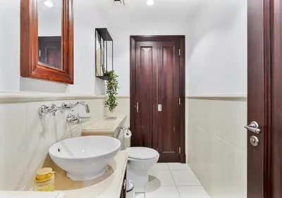 a bathroom with a white toilet and a sink at 2BR Downtown Dubai 5 Min Walk to Dubai Mall & Burj in Dubai