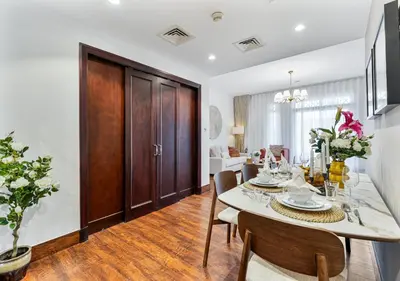 a kitchen and dining room with a table and chairs at 2BR Downtown Dubai 5 Min Walk to Dubai Mall & Burj in Dubai