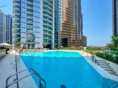 a large swimming pool in a city with tall buildings at Modern Waterfront Living with Stunning Views in Dubai