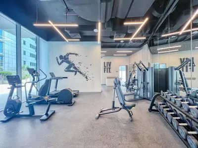 a gym with treadmills and exercise bikes in a room at Modern Waterfront Living with Stunning Views in Dubai