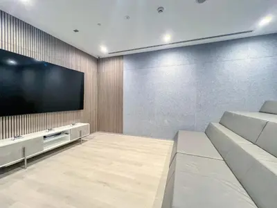a living room with a large flat screen tv at Modern Waterfront Living with Stunning Views in Dubai
