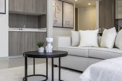 a living room with a couch and a table at Stylish Coastal Living with Premium Amenities in Dubai
