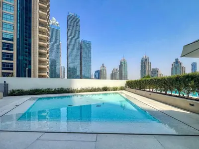 a swimming pool with a city skyline in the background at Stylish Coastal Living with Premium Amenities in Dubai