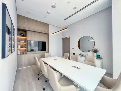 a conference room with a white table and chairs at Stylish Coastal Living with Premium Amenities in Dubai