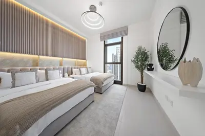 a bedroom with two beds and a large mirror at DVH Luxe Retreats 2 Bedroom Downtown by Burj Khalifa and Dubai Mall in Dubai
