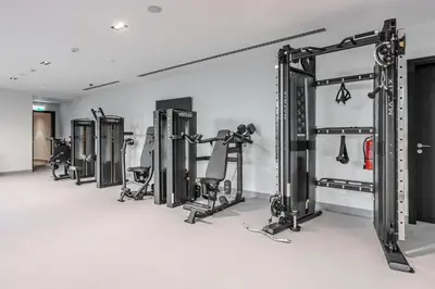 a row of tread machines in a gym at DVH Luxe Retreats 2 Bedroom Downtown by Burj Khalifa and Dubai Mall in Dubai
