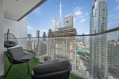 a balcony with chairs and a view of a city at DVH Luxe Retreats 2 Bedroom Downtown by Burj Khalifa and Dubai Mall in Dubai