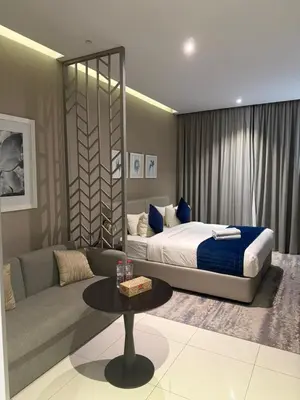 a living room with a bed and a couch at Royal Montania by DAMAC Maison Prive in Dubai
