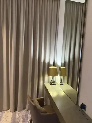 a mirror and a desk with a chair and a lamp at Royal Montania by DAMAC Maison Prive in Dubai