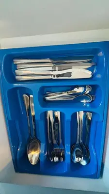 a blue tray with forks and spoons and utensils at Royal Montania by DAMAC Maison Prive in Dubai