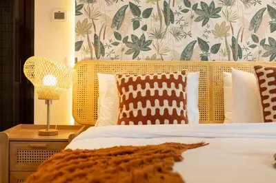 a bedroom with a bed with a wooden headboard and pillows at Luxury 5 Star Newly Furnished 3BR Apartment in Dubai Marina in Dubai