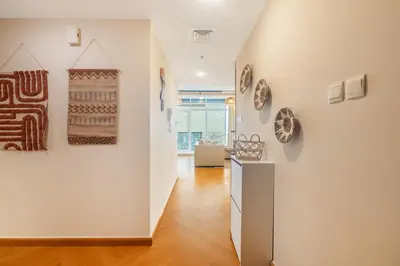 a hallway with artworks on the wall and a staircase at Luxury 5 Star Newly Furnished 3BR Apartment in Dubai Marina in Dubai
