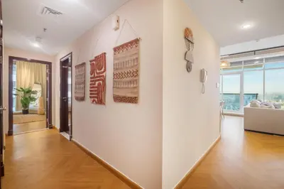 a hallway with white walls and wooden floors at Luxury 5 Star Newly Furnished 3BR Apartment in Dubai Marina in Dubai