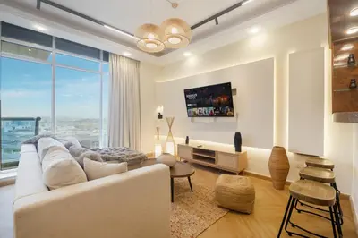 a living room with a white couch and a large window at Luxury 5 Star Newly Furnished 3BR Apartment in Dubai Marina in Dubai