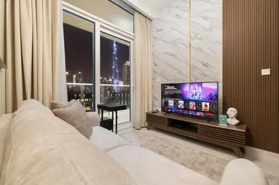 a living room with a couch and a large window at New 1BR with Burj Khalifa Views Near Dubai Mall in Dubai
