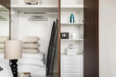 a bedroom with a closet with pillows and a mirror at New 1BR with Burj Khalifa Views Near Dubai Mall in Dubai