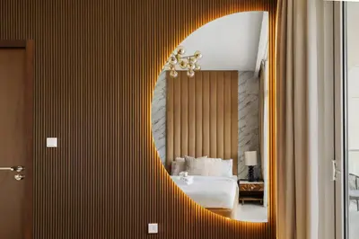a bedroom with a bed and a mirror on a wall at New 1BR with Burj Khalifa Views Near Dubai Mall in Dubai