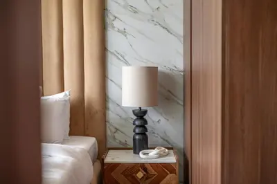 a lamp on a table next to a bed at New 1BR with Burj Khalifa Views Near Dubai Mall in Dubai