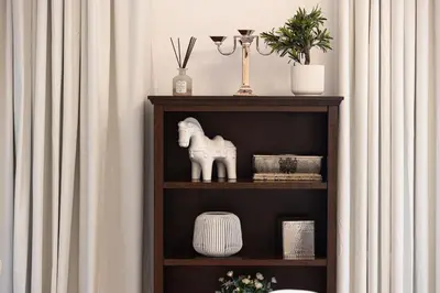 a book shelf with a statue of a horse on it at Elegant 1-BR in Downtown Dubai's Old Town in Dubai