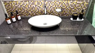 a bathroom sink with bottles of wine on a counter at LUX 1BR 5 Min Walk Dubai Mall - DAMAC Upper Crest in Dubai