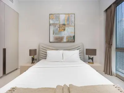 a bedroom with a white bed and two lamps at Grande Signature 2BR Burj Khalifa & Dubai Fountain in Dubai