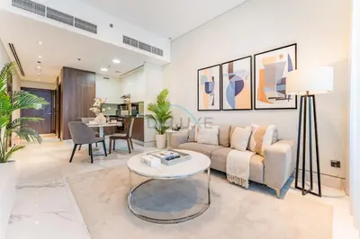 a living room with a couch and a table at Stunning 1BR with Panoramic Canal Views, Convenient Downtown Access and Walking Distance to Bus Stop, J One - 1, Business Bay by Deluxe Holiday Homes in Dubai