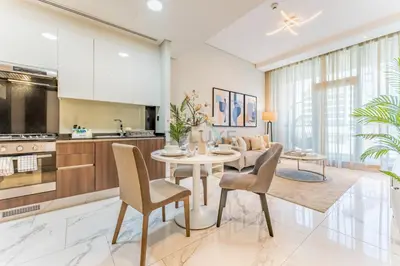 a kitchen and dining room with a table and chairs at Stunning 1BR with Panoramic Canal Views, Convenient Downtown Access and Walking Distance to Bus Stop, J One - 1, Business Bay by Deluxe Holiday Homes in Dubai