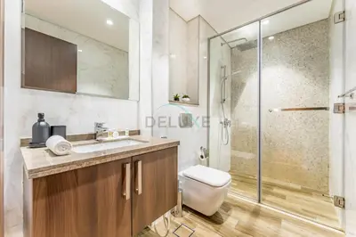 a bathroom with a toilet and a shower at Stunning 1BR with Panoramic Canal Views, Convenient Downtown Access and Walking Distance to Bus Stop, J One - 1, Business Bay by Deluxe Holiday Homes in Dubai