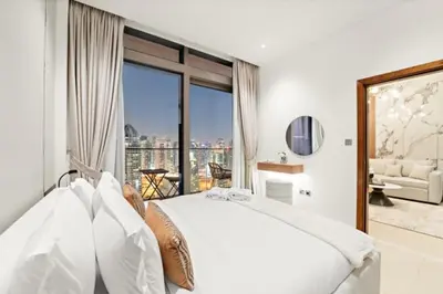 a bedroom with a large white bed and a large window at FIRST CLASS 1BR Breathtaking Marina Views in Dubai
