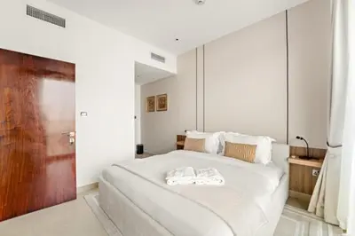a bedroom with a large bed with two towels on it at FIRST CLASS 1BR Breathtaking Marina Views in Dubai