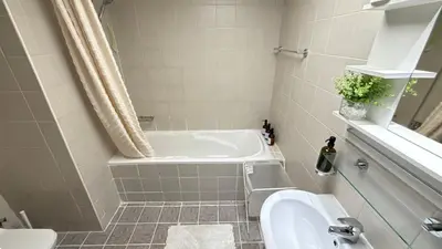 a bathroom with a tub and a sink at Studio with Amazing Lake Views in Arch Tower, JLT in Dubai