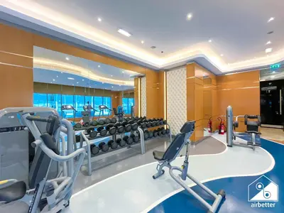 a fitness room with a gym with machines at Luxury 2-Bedroom Apartment, Downtown Skyline Views in Dubai