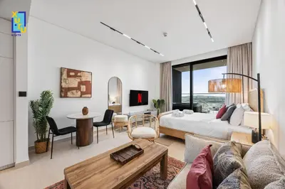 a bedroom with a bed and a living room at Timeless & Textured Studio w Jacuzzi Trillionaire in Dubai