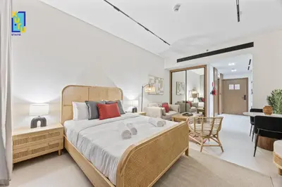 a bedroom with a large bed and a living room at Timeless & Textured Studio w Jacuzzi Trillionaire in Dubai