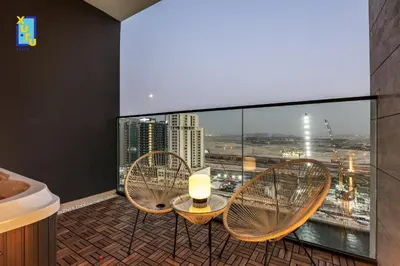 a bathroom with three chairs and a table on a balcony at Timeless & Textured Studio w Jacuzzi Trillionaire in Dubai