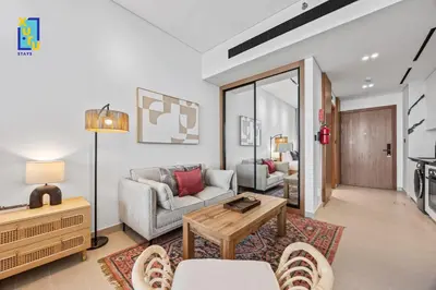 a living room with a couch and a table at Timeless & Textured Studio w Jacuzzi Trillionaire in Dubai