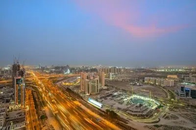 a city with a lot of traffic at night at FIRST CLASS Studio Stylish , Prime Location in Dubai