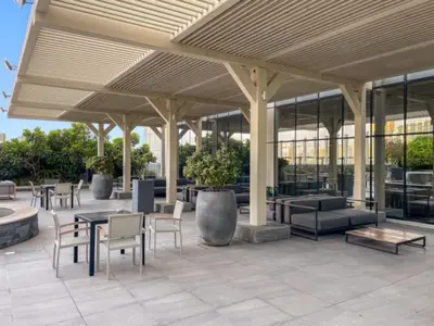 a patio with tables and chairs in a building at FIRST CLASS Studio Stylish , Prime Location in Dubai