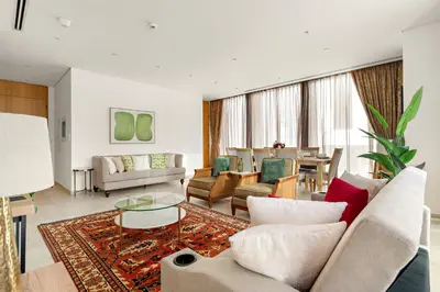 a living room with a couch and a table at FIRST CLASS 3BR Comfort and Style , Business Bay in Dubai