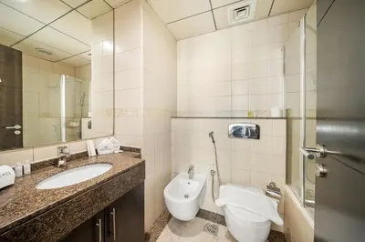 a bathroom with a toilet and a sink at FIRST CLASS 1BR Marina Skyline Escape in Dubai