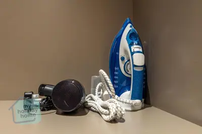 a hair dryer and a microphone on a counter at Modern 1BR in JVC Pool, Gym & Free Parking in Dubai
