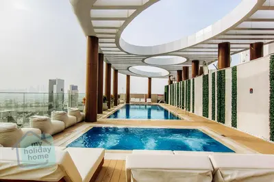 a swimming pool in a hotel lobby with a view at Modern 1BR in JVC Pool, Gym & Free Parking in Dubai