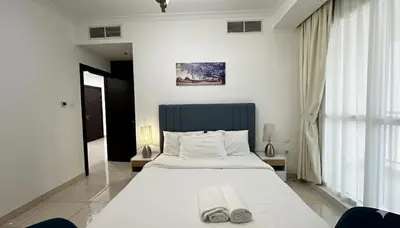 a bedroom with a large bed with two slippers on it at Stylish 1BR Canal View Apartment Business Bay in Dubai