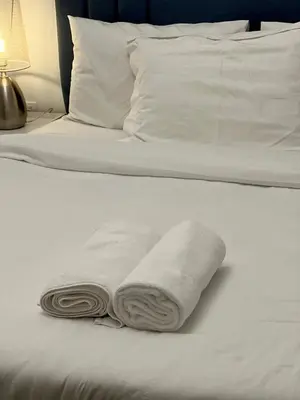 a couple of towels are sitting on a bed at Stylish 1BR Canal View Apartment Business Bay in Dubai