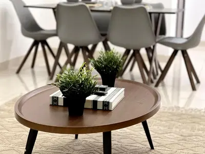 a coffee table with two plants and a book on it at Stylish 1BR Canal View Apartment Business Bay in Dubai