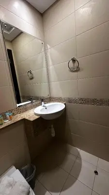 a bathroom with a sink and a mirror at Stylish 1BR Canal View Apartment Business Bay in Dubai