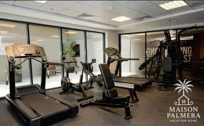 a gym with several treadmills and elliptical machines at Park Vista-Infinity Pool View in Dubai