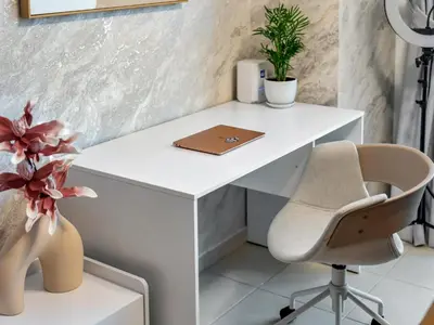 an office with a white desk and a chair at Panoramic Burj 5br Condo with Full Led & Fountain View in Dubai